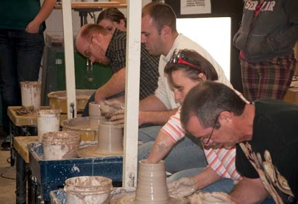 Teachers throwing clay on a pottery wheel